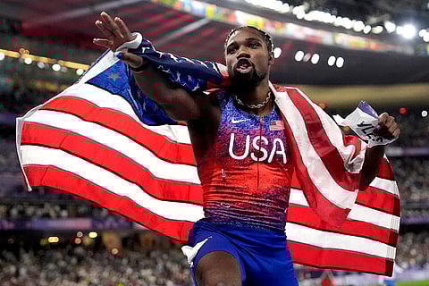 Noah Lyles celebrates after winning gold in the men's 100-meters final